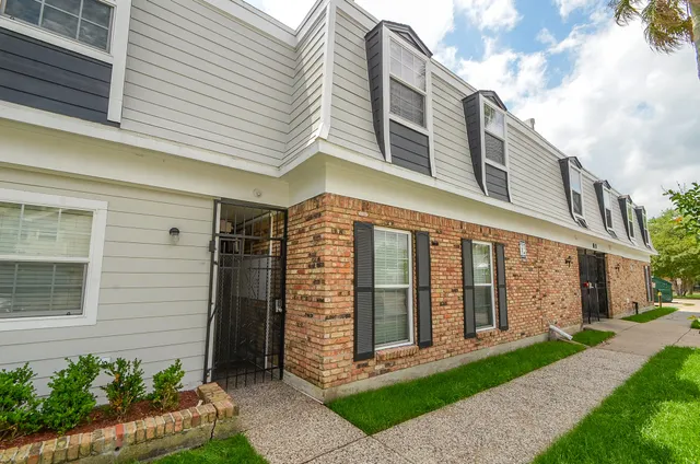 a front view of a building with a garden