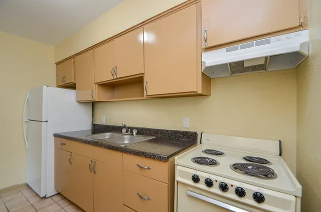 a kitchen with stainless steel appliances granite countertop a stove and a cabinets