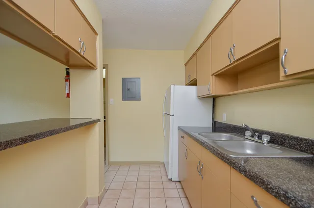 a kitchen with stainless steel appliances granite countertop a sink and a granite counter tops