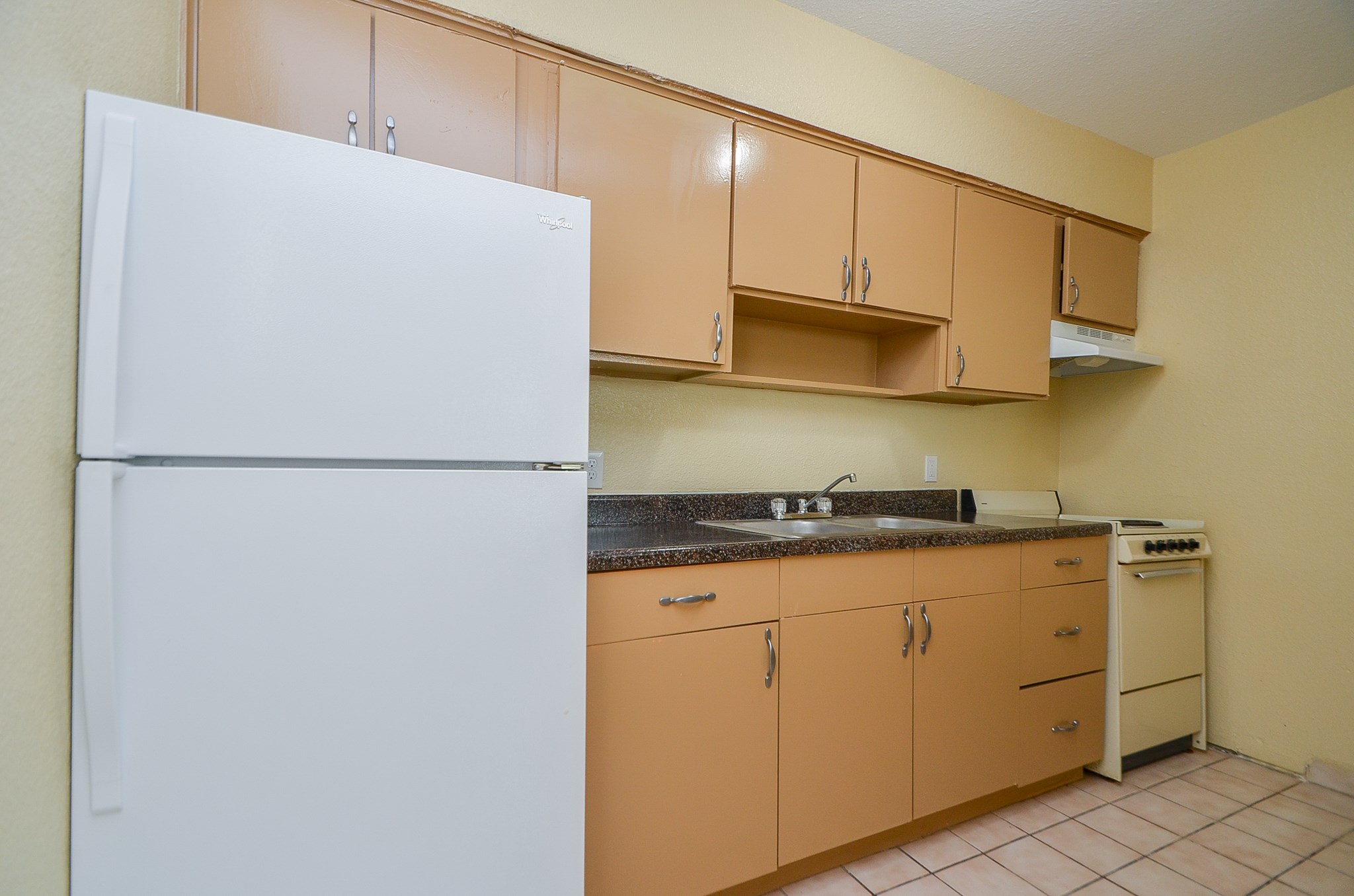 1419 Hawthorne Street, Unit 21 Houston, TX 77006 - Photo 16 of 24 a kitchen with stainless steel appliances granite countertop a refrigerator a stove a sink and white cabinets