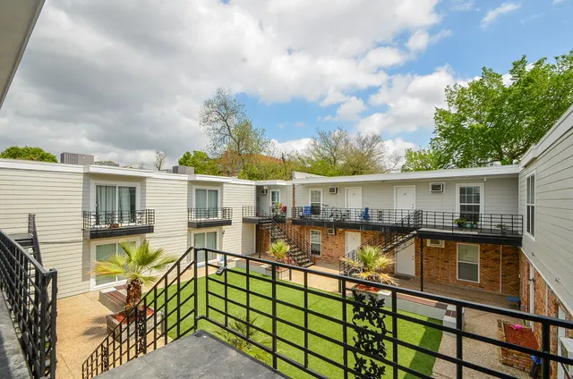 a view of a house with pool and chairs