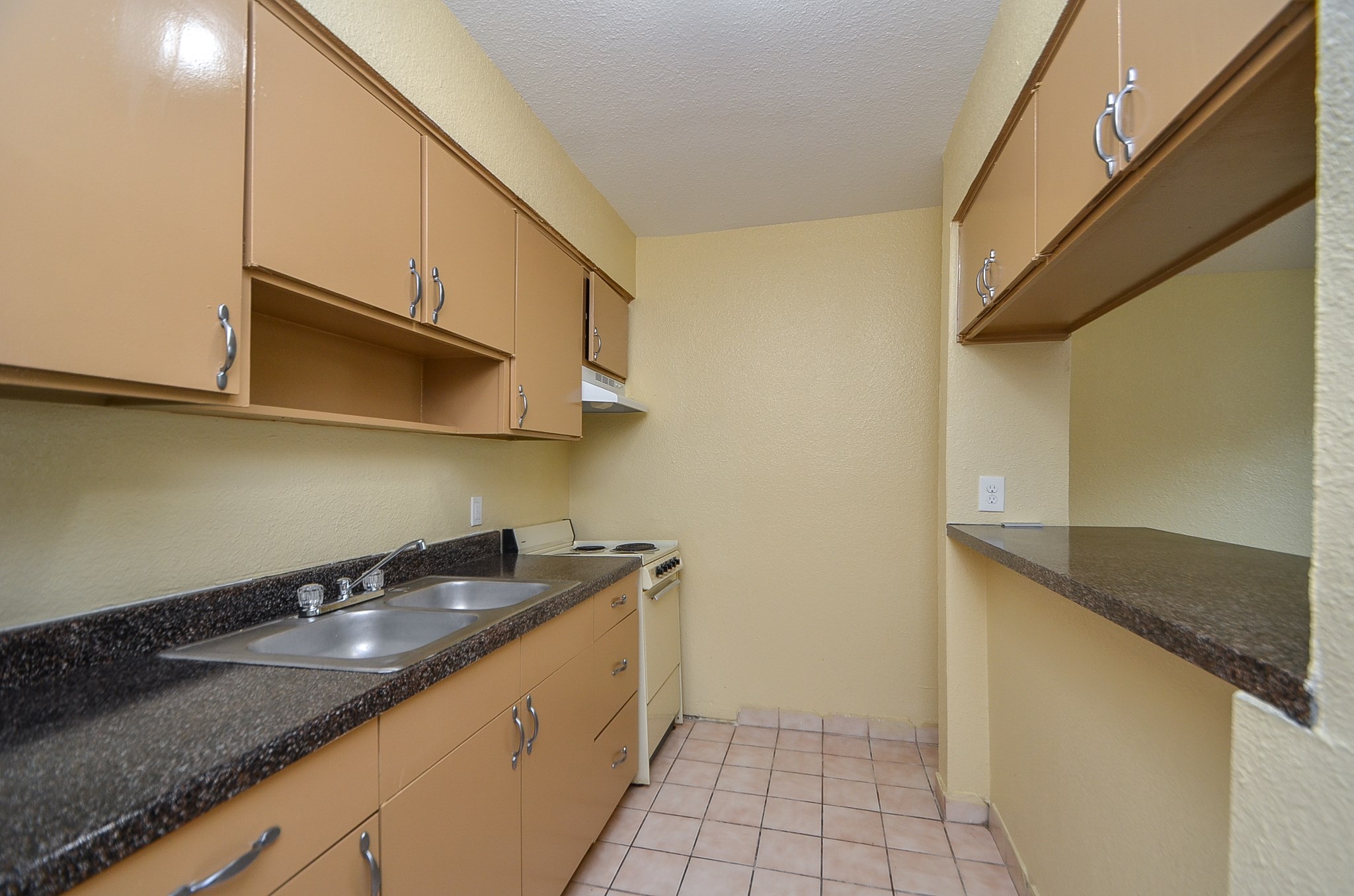 1419 Hawthorne Street, Unit 21 Houston, TX 77006 - Photo 10 of 24 a kitchen with granite countertop a sink a stove and cabinets