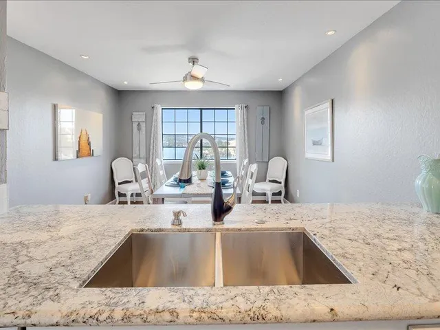 a kitchen with a sink and a granite top