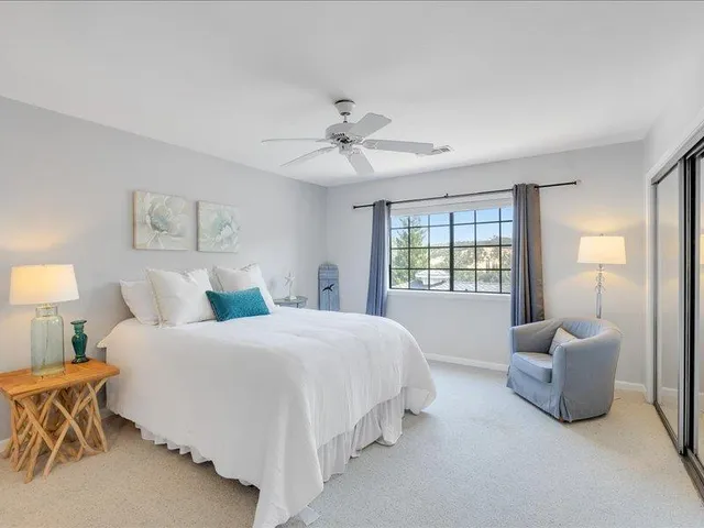 a spacious bedroom with a bed and a couch