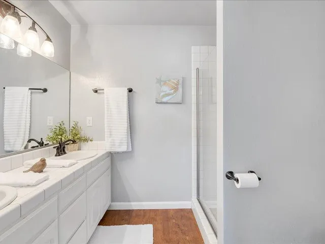 a bathroom with a bathtub sink and mirror