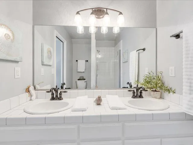 a bathroom with a double vanity sink and a mirror