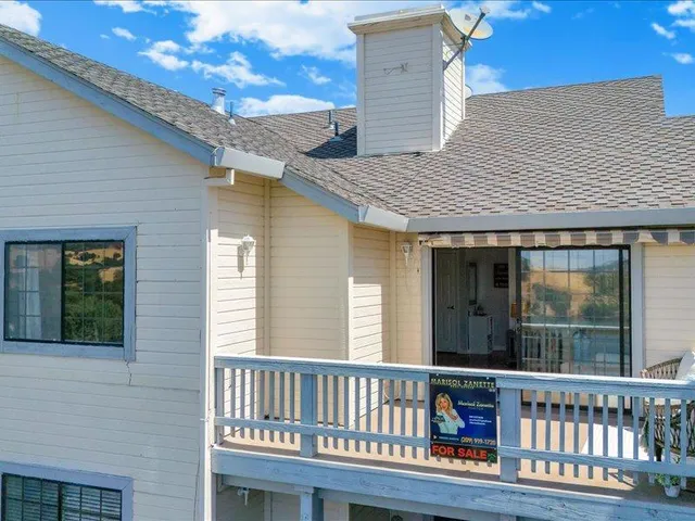a view of a chair and table on the deck