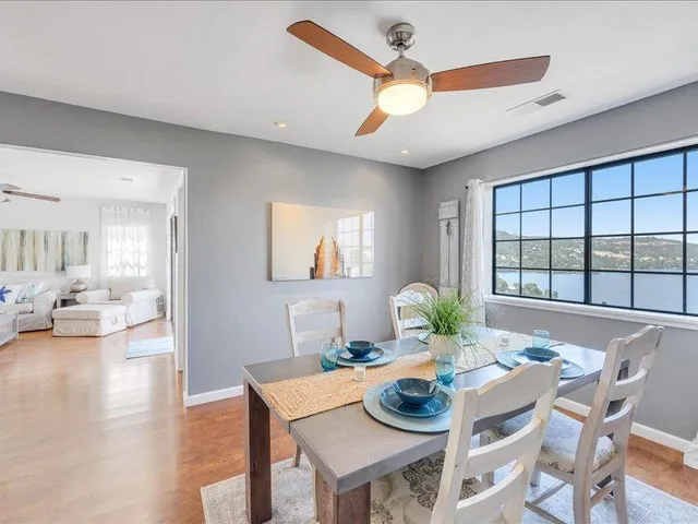 a view of a dining room with furniture and a large window