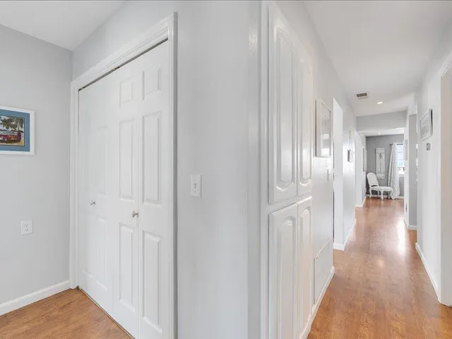 a view of a hallway with a wooden floor