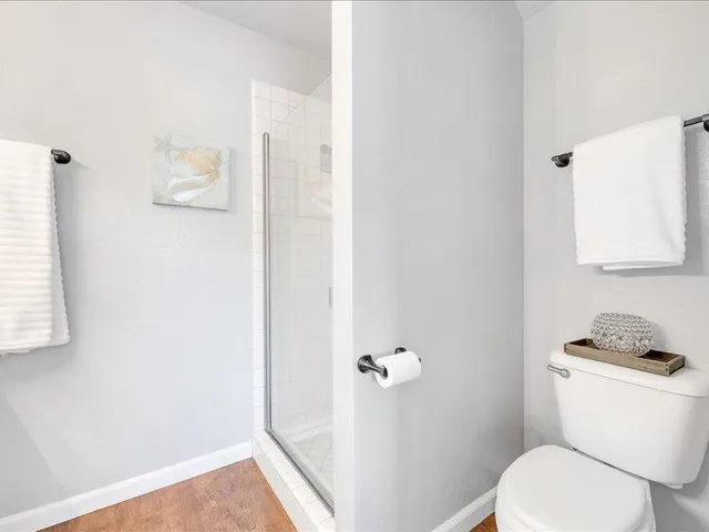 a white toilet sitting next to a bathroom sink