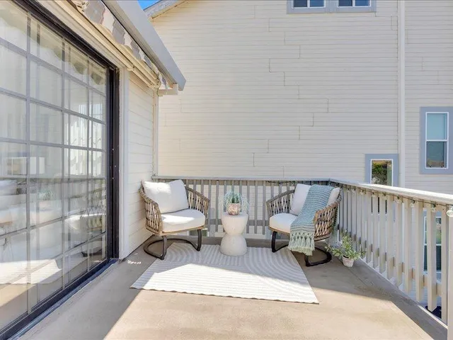 a view of a balcony with furniture