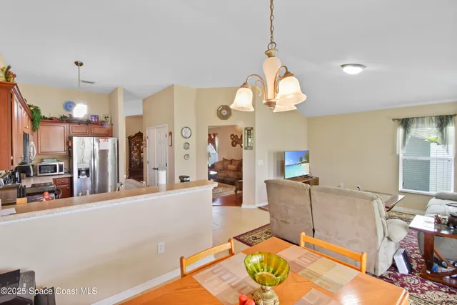 a living room with furniture a fireplace and a chandelier