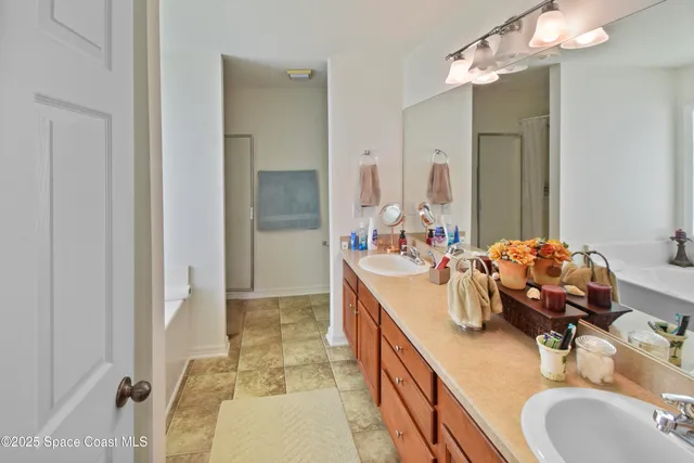 a en suite bathroom with a double vanity sink and a mirror