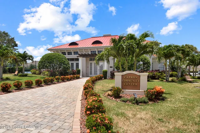 a backyard of a house with a garden and barbeque oven