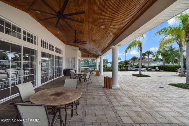 a view of a patio with a dining table and chairs
