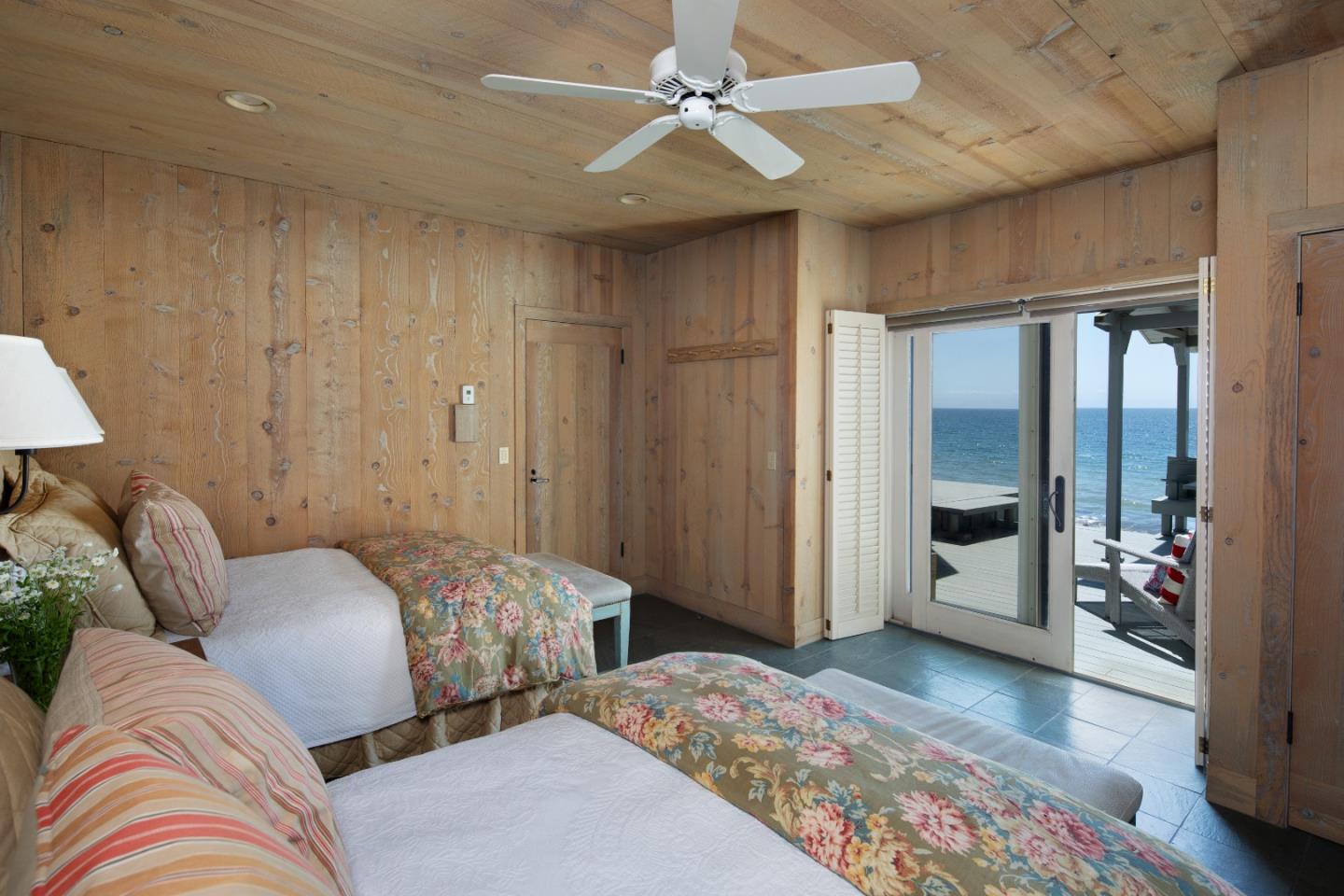 14 Potbelly Beach Road Aptos, CA 95003 - Photo 5 of 14 a bedroom with a large bed and a chandelier