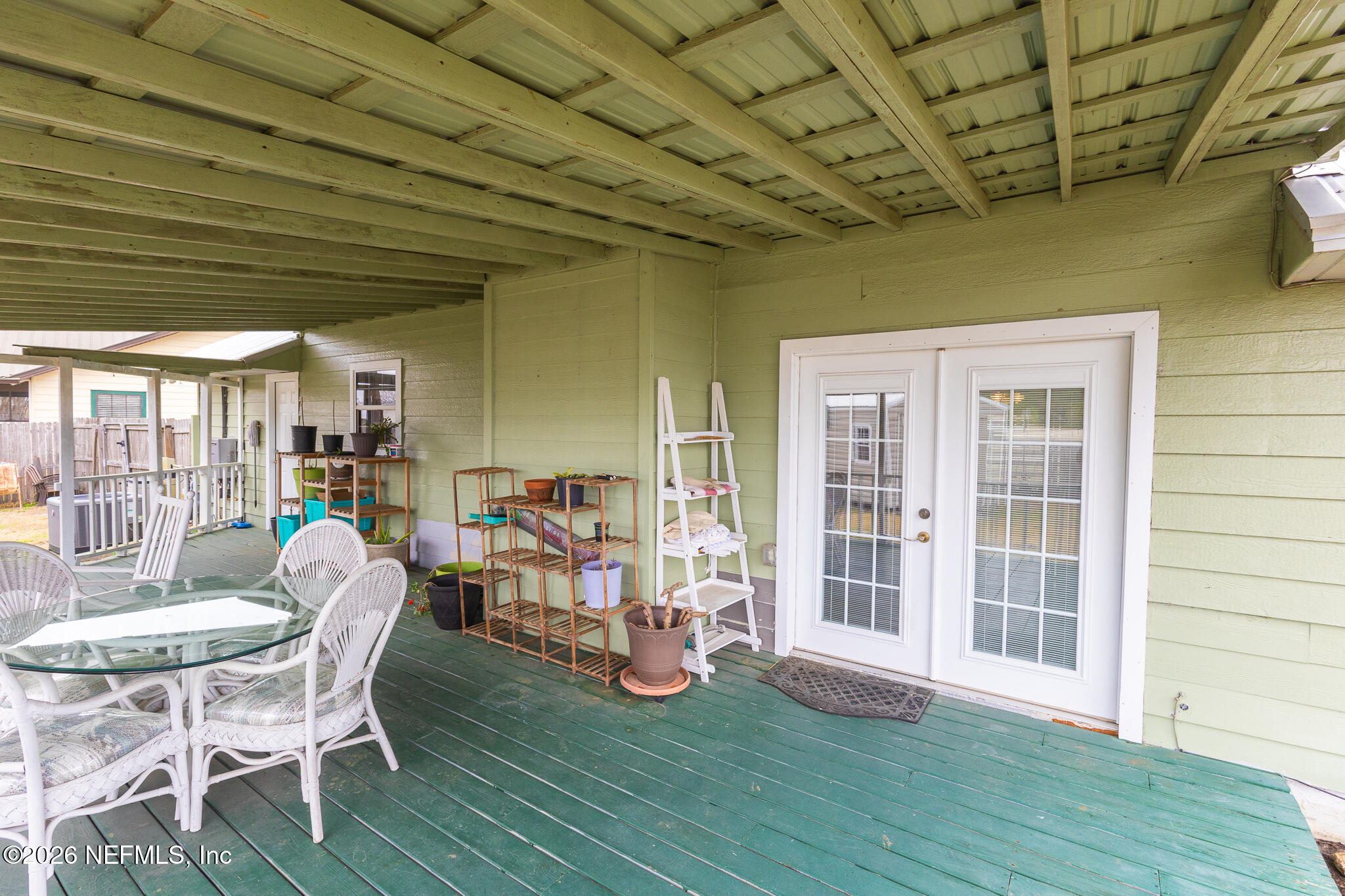 6110 4th Manor West Palatka, FL 32177 - Photo 11 of 44 a dining room with furniture wooden floor and a garden