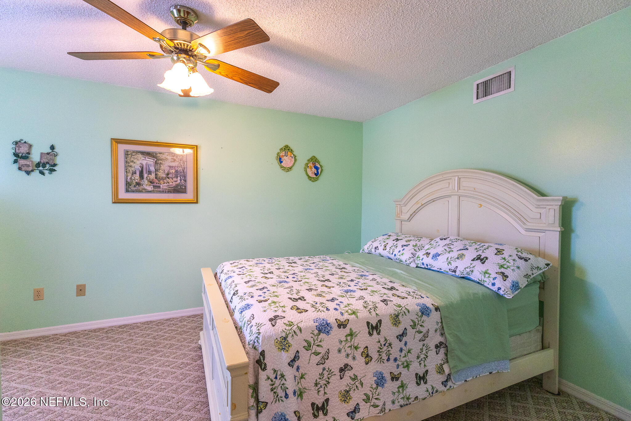6110 4th Manor West Palatka, FL 32177 - Photo 18 of 44 a bedroom with a bed and a chandelier