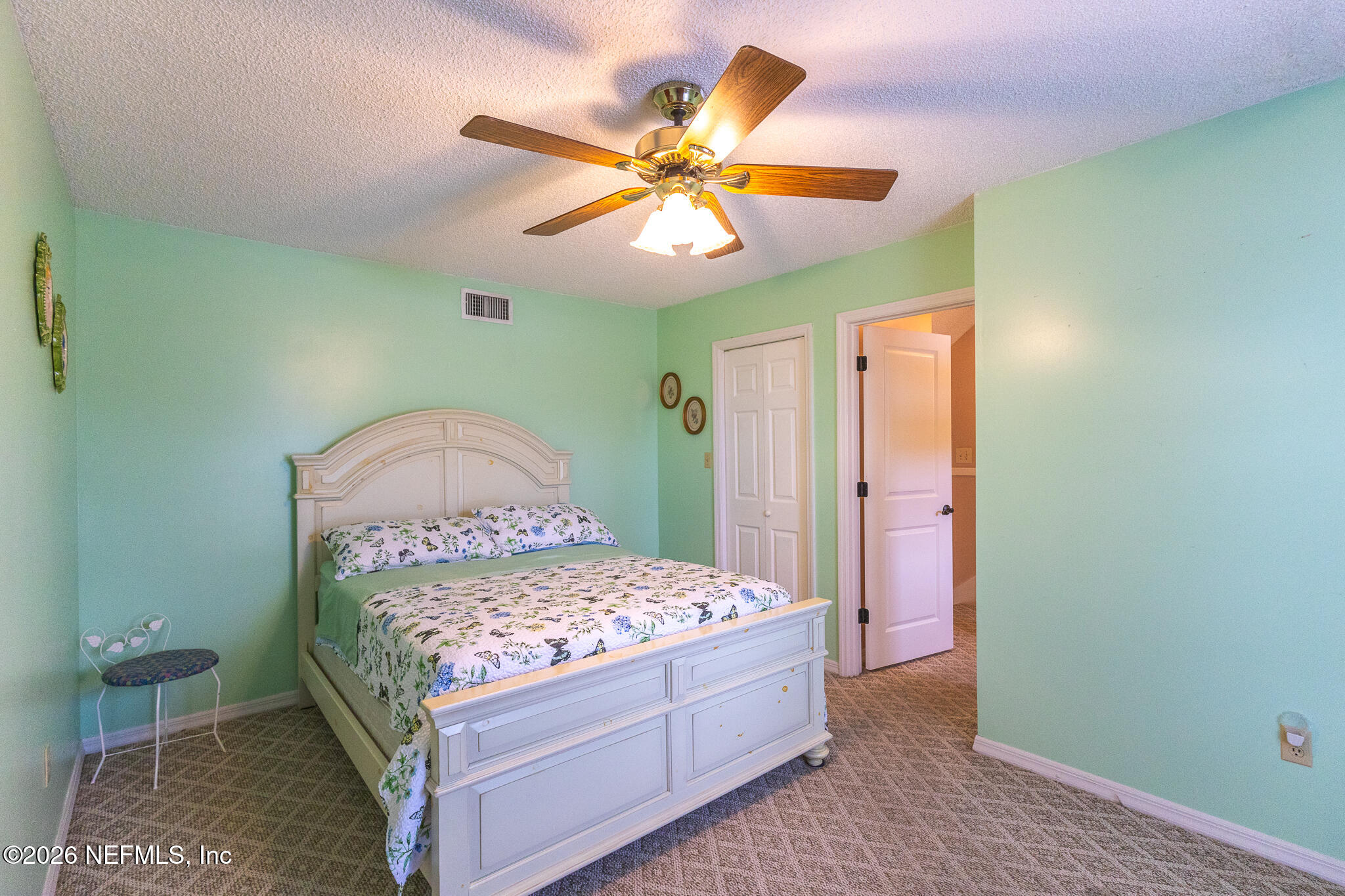 6110 4th Manor West Palatka, FL 32177 - Photo 19 of 44 a bedroom with a bed and a chandelier