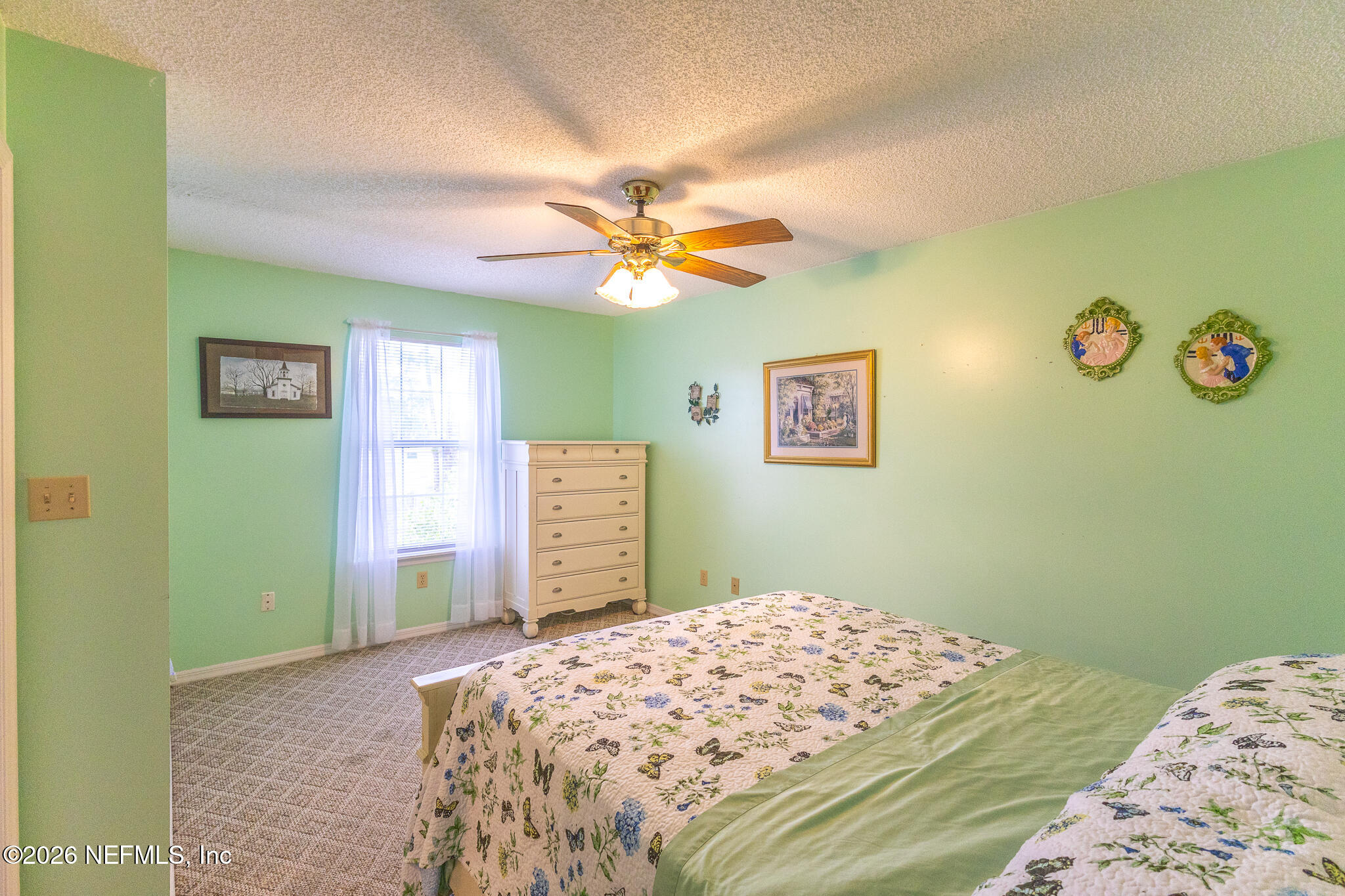 6110 4th Manor West Palatka, FL 32177 - Photo 20 of 44 a bedroom with a bed and a chandelier