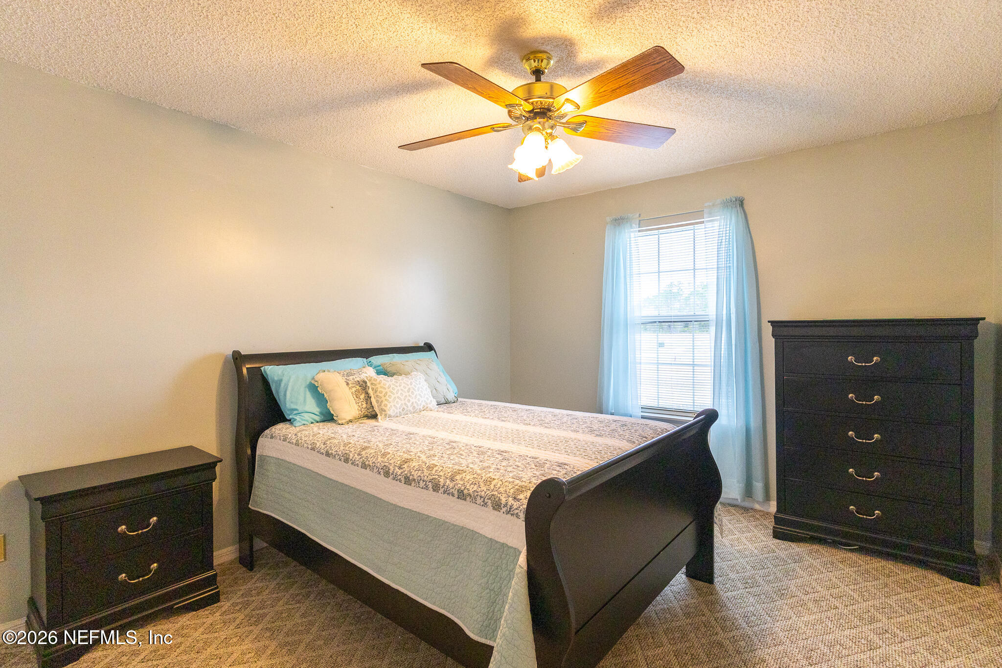6110 4th Manor West Palatka, FL 32177 - Photo 24 of 44 a bedroom with a bed and a ceiling fan