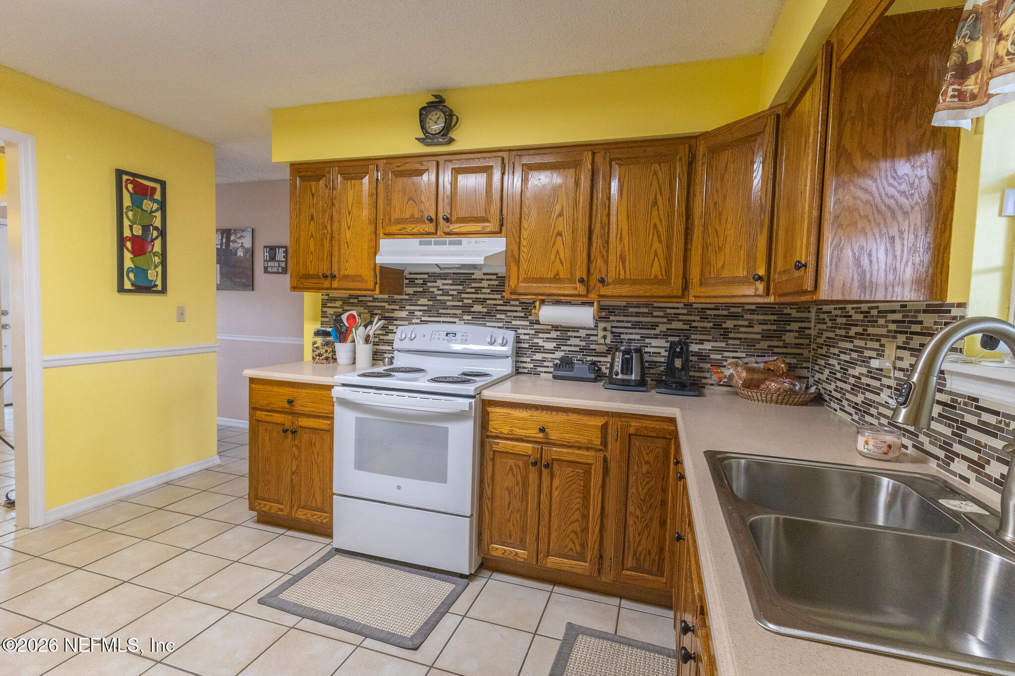 6110 4th Manor West Palatka, FL 32177 - Photo 30 of 44 a kitchen with stainless steel appliances granite countertop a sink stove and cabinets