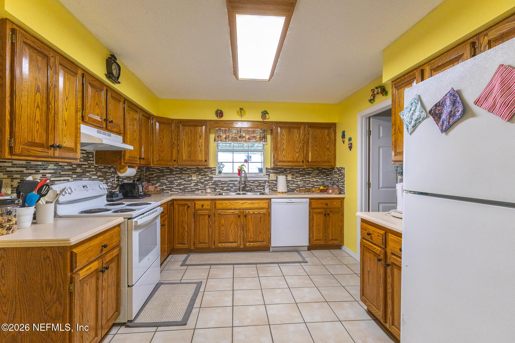 6110 4th Manor West Palatka, FL 32177 - Photo 31 of 44 a kitchen with stainless steel appliances granite countertop a refrigerator a stove top oven and a sink