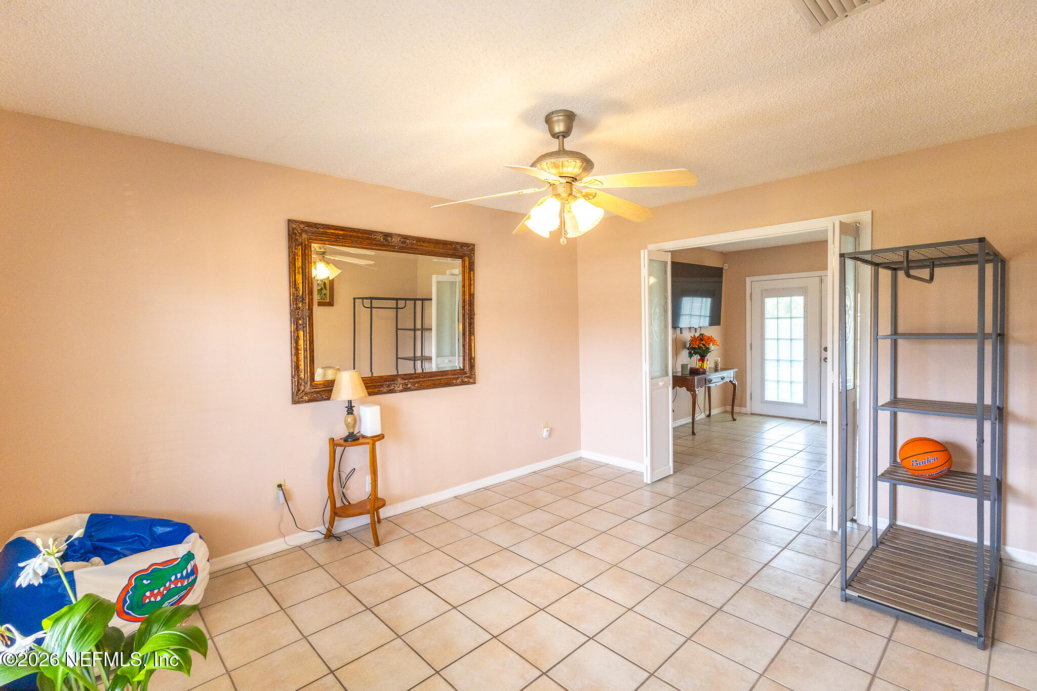 6110 4th Manor West Palatka, FL 32177 - Photo 39 of 44 a bedroom with a bed and a chandelier