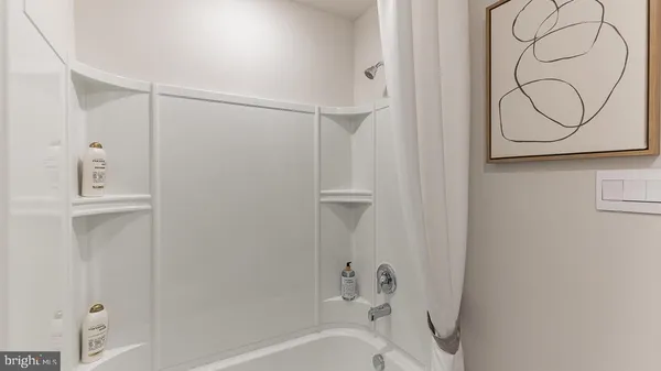 a bathroom with a bathtub and shower