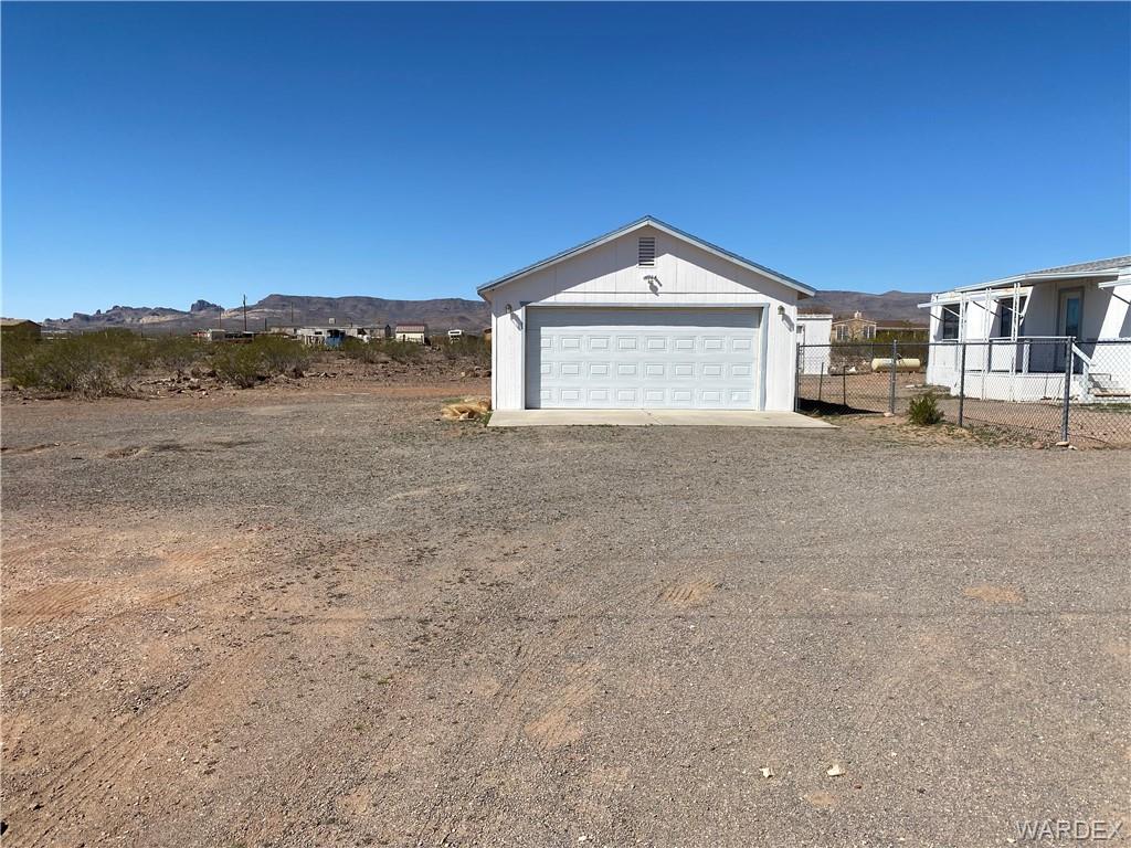 4649 Eden Road Golden Valley, AZ 86413 - Photo 20 of 26 a view of a house with a yard and large tree