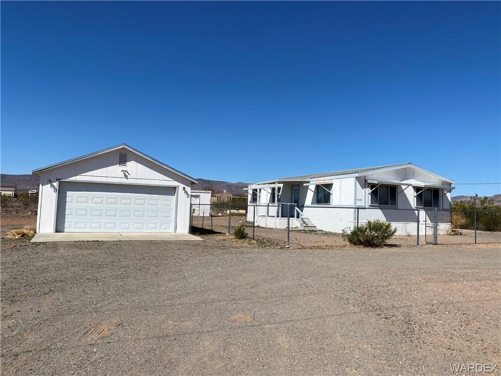 4649 Eden Road Golden Valley, AZ 86413 - Photo 2 of 26 a view of a house with a yard and garage