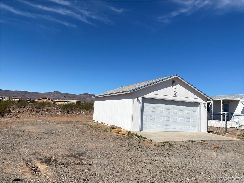 4649 Eden Road Golden Valley, AZ 86413 - Photo 21 of 26 a front view of a house with a yard