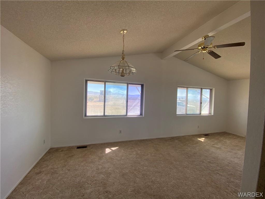 4649 Eden Road Golden Valley, AZ 86413 - Photo 7 of 26 en empty room with windows and ceiling fan view