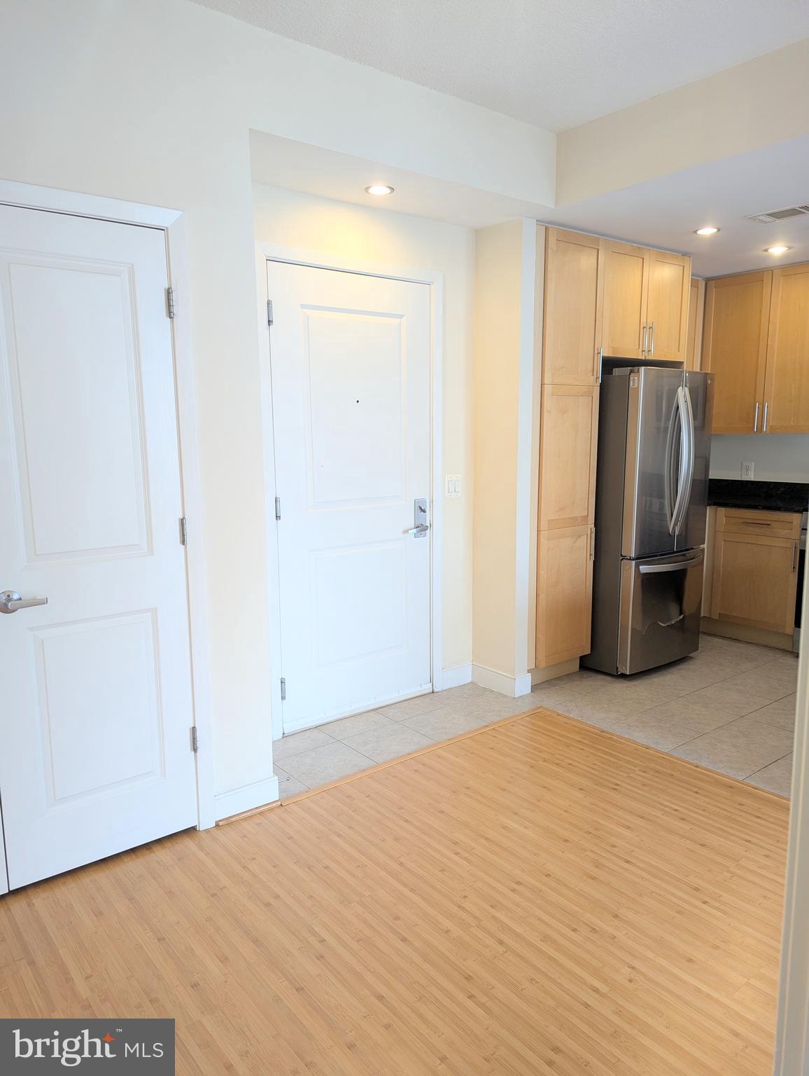 820 North Pollard Street, Unit 810 Arlington, VA 22203 - Photo 14 of 49 a view of an empty room with wooden floor and a cabinet