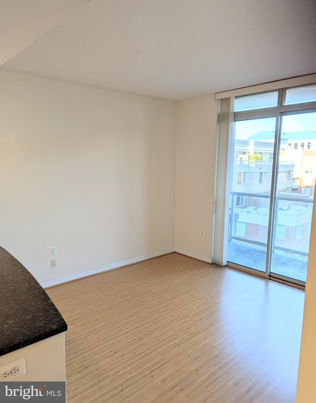 820 North Pollard Street, Unit 810 Arlington, VA 22203 - Photo 21 of 49 a view of an empty room with wooden floor and a window