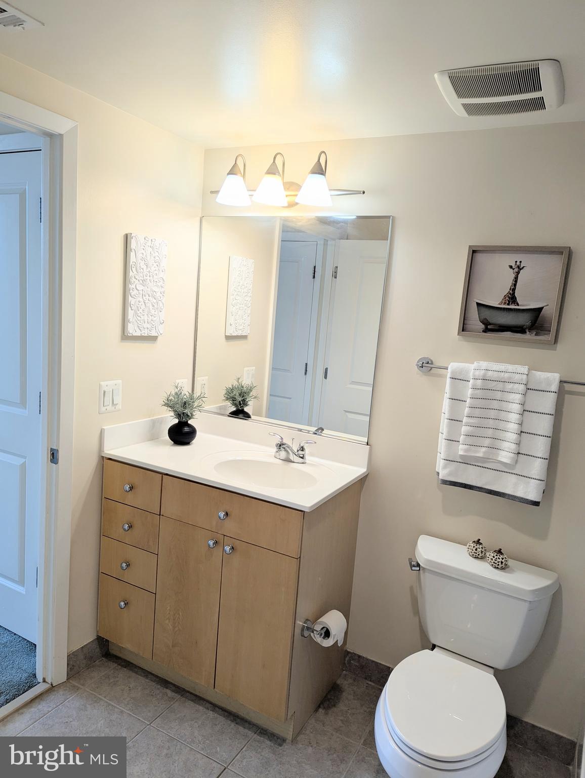 820 North Pollard Street, Unit 810 Arlington, VA 22203 - Photo 26 of 49 a bathroom with a toilet sink and mirror