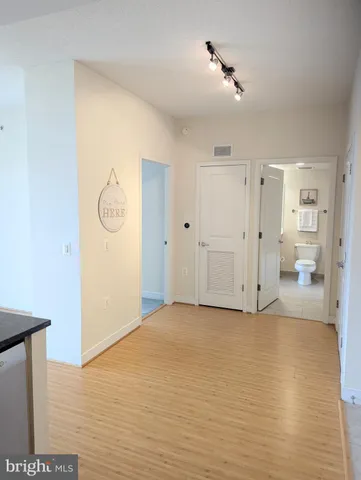 a bathroom with a bathtub shower sink vanity and a toilet