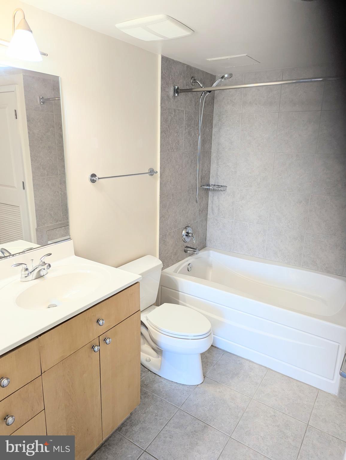 820 North Pollard Street, Unit 810 Arlington, VA 22203 - Photo 30 of 49 a bathroom with a bathtub shower sink vanity and toilet