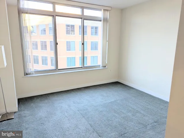a view of a hallway with toilet and tub