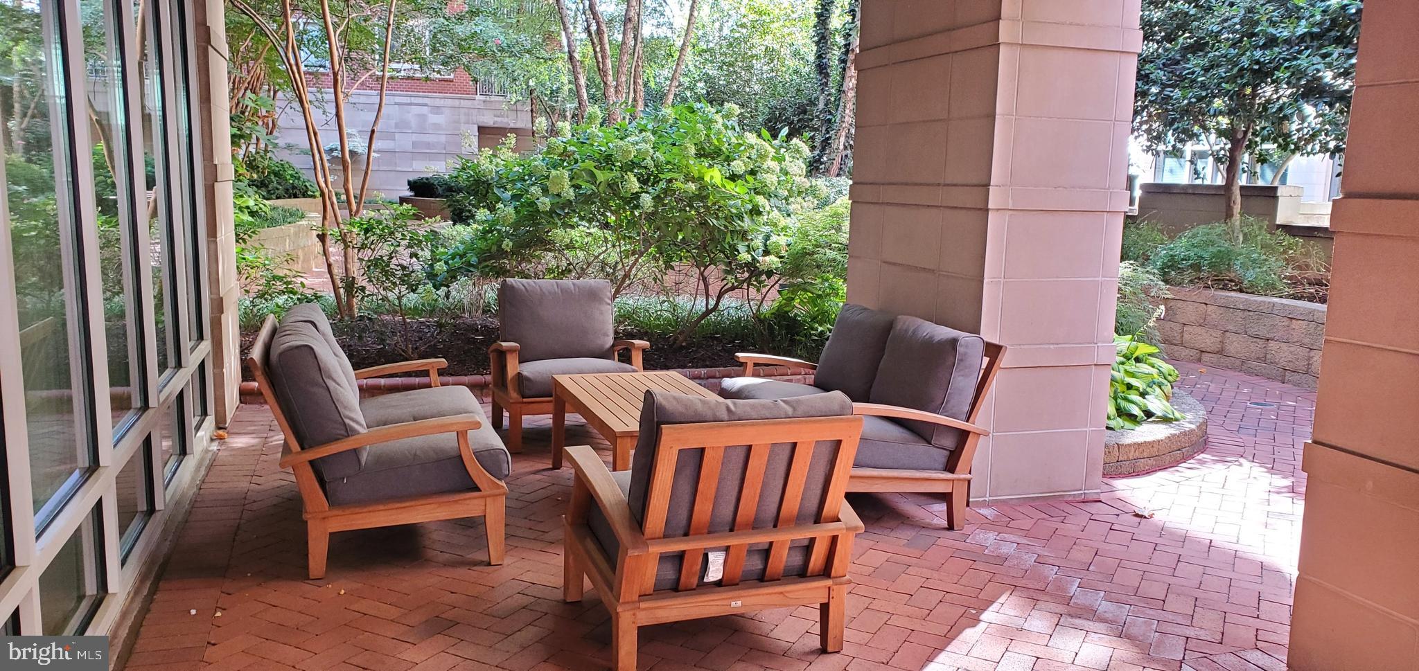 820 North Pollard Street, Unit 810 Arlington, VA 22203 - Photo 40 of 49 a view of a patio with table and chairs and potted plants