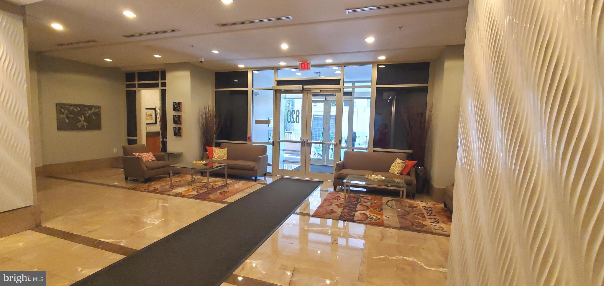 820 North Pollard Street, Unit 810 Arlington, VA 22203 - Photo 42 of 49 a living room with stainless steel appliances furniture a rug and a kitchen
