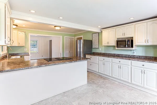 a kitchen with stainless steel appliances granite countertop a stove and a refrigerator