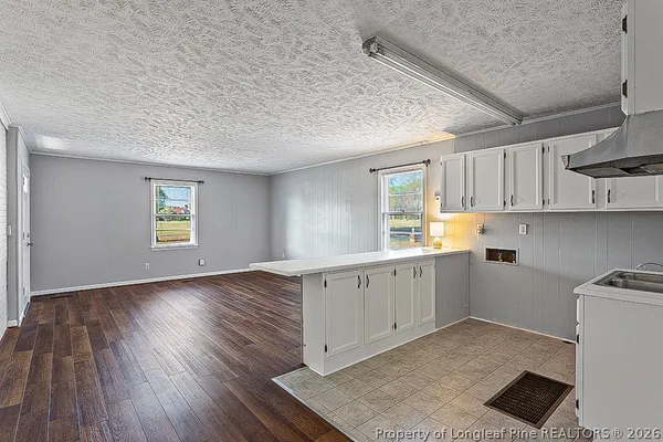a kitchen with sink cabinets and window