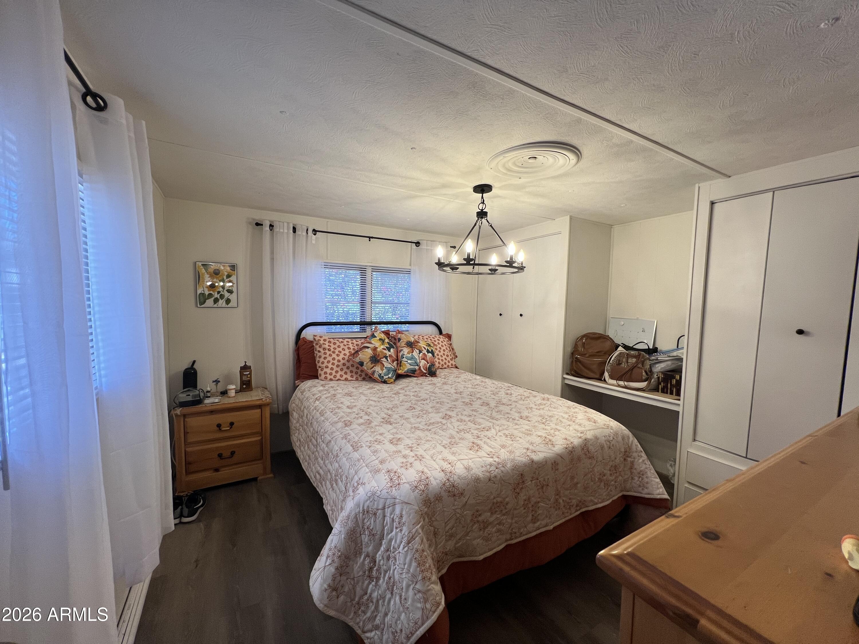 19225 North Cave Creek Road, Unit 40 Phoenix, AZ 85024 - Photo 14 of 21 a bedroom with a bed and a table