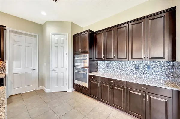 a large kitchen with granite countertop lots of counter space and window