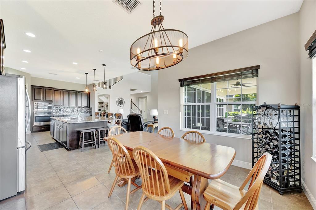 6324 Brevada Lane Apollo Beach, FL 33572 - Photo 19 of 45 a dining room with furniture a chandelier and window