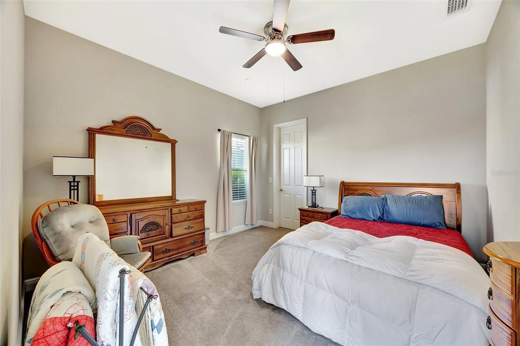 6324 Brevada Lane Apollo Beach, FL 33572 - Photo 20 of 45 a bedroom with a bed and dresser