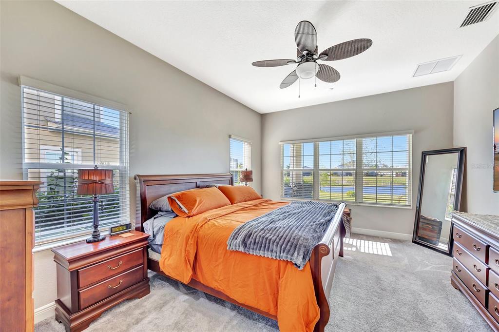 6324 Brevada Lane Apollo Beach, FL 33572 - Photo 24 of 45 a bedroom with a bed and a chandelier