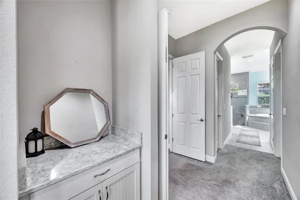 a large bathroom with a double vanity sink a large mirror and a bathtub