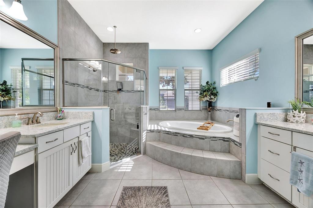 6324 Brevada Lane Apollo Beach, FL 33572 - Photo 25 of 53 a large bathroom with a double vanity sink a large mirror and a bathtub
